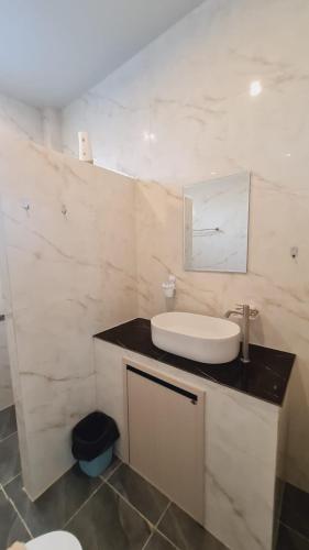 a white bathroom with a sink and a mirror at Samati Hill - Sunset Pool Villa 6 - Klong Ning Beach in Ko Lanta Yai