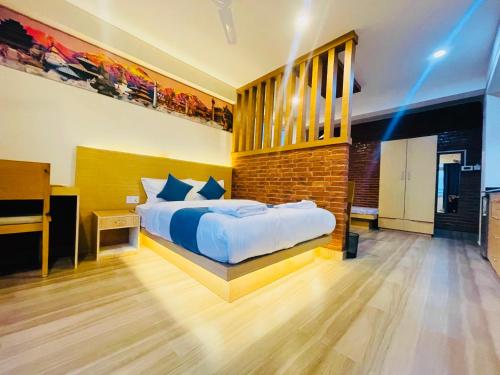 a bedroom with a bed and a brick wall at Pokhara Apartments Inn in Pokhara