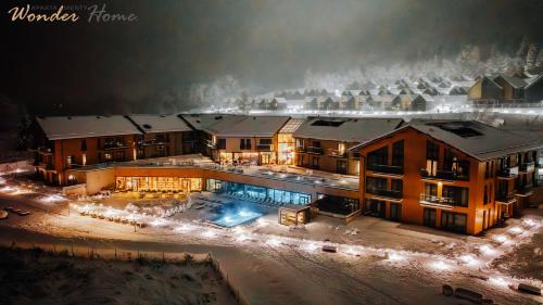 an aerial view of a mansion at night with lights at Wonder Hill - apartamenty hotelowe z dostępem do basenów i jacuzzi in Sosnówka