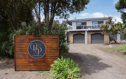 a house with a sign in front of it at Beacon Point House in Port Campbell