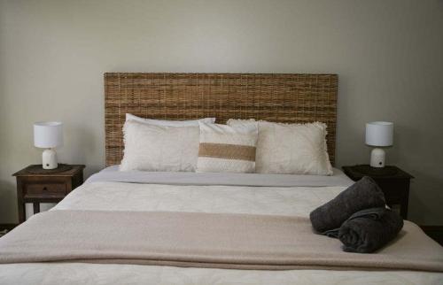 a bedroom with a large bed with two night stands at Beacon Point House in Port Campbell