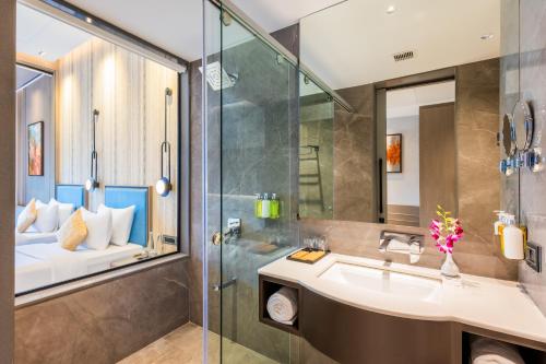 a bathroom with a sink and a shower at Enrise by Sayaji Bhopal in Bhopal