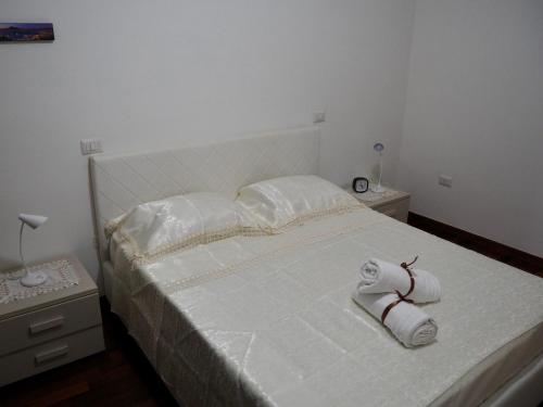 a bedroom with a bed with towels on it at Casa Martina in Castellammare di Stabia