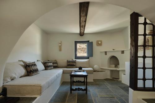 uma sala de estar com um sofá e uma mesa em Liostasi Ona Villa em Ios Chora