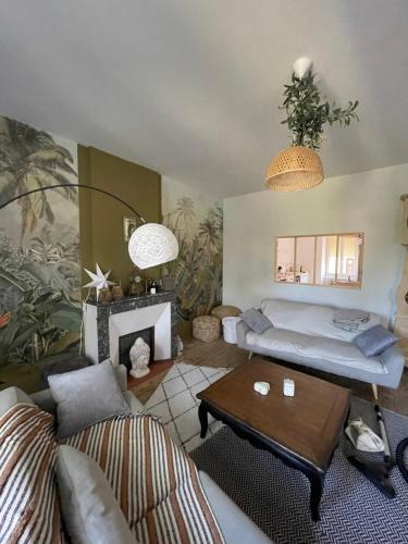 a living room with a couch and a table at Maison avec Jardin 3 chambres entre Tarn et Aveyron in Carmaux