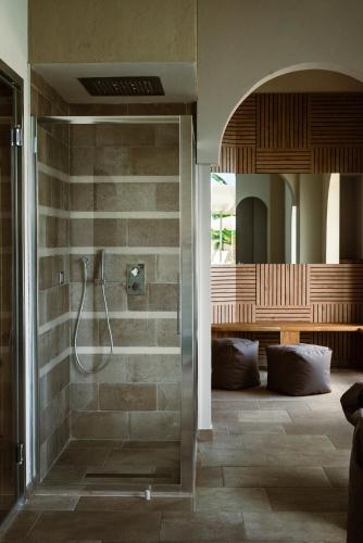 a bathroom with a shower with a glass door at Tenuta Masseria & Spa Chicco Rizzo in Sternatia
