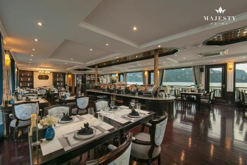 a restaurant with tables and chairs in a room at Majesty Luxury Prime Cruise by Premier Group in Ha Long