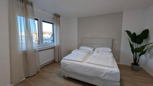 En eller flere senge i et værelse på HarmoNest Rheydt Apartments