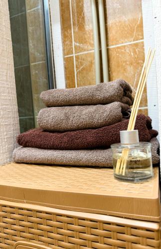 a stack of towels on top of a wooden table at Kyiv Gelik Apartment in Kyiv