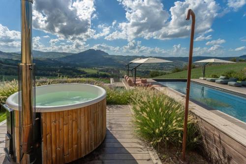 a jacuzzi tub sitting next to a pool at Palazzo Serre - Natura & Piscina in San Leo