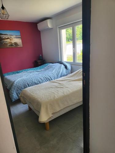 a bedroom with two beds and a window at La maison de la Motte in La Motte-Fanjas
