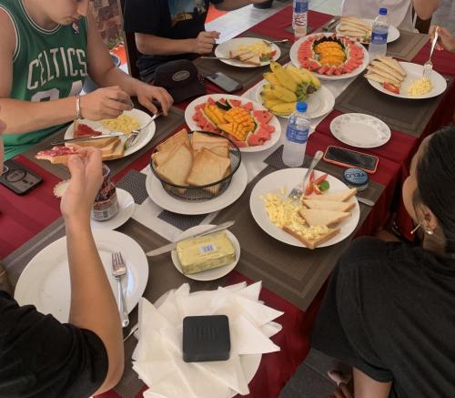 a group of people sitting around a table with plates of food at Yathramulla Harbour Bentota in Bentota