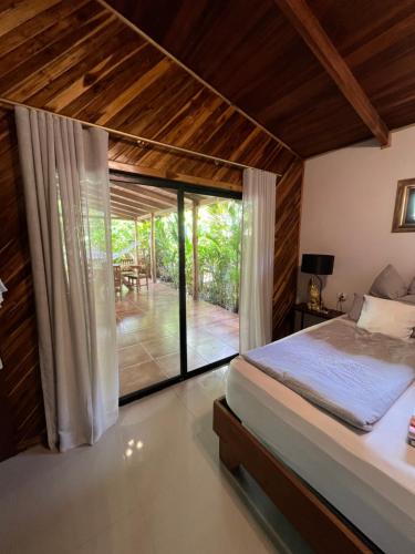 a bedroom with a bed and a view of a patio at Casa Adam in Pochote