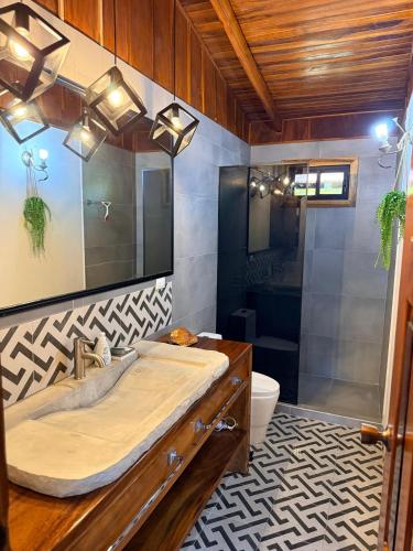 a bathroom with a large sink and a shower at Casa Adam in Pochote