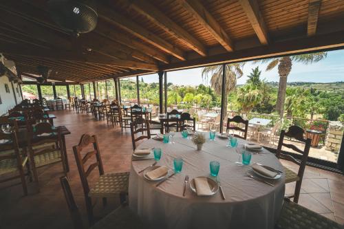 a long table with plates and napkins on it in a restaurant at HolaCamp Albufeira in Albufeira