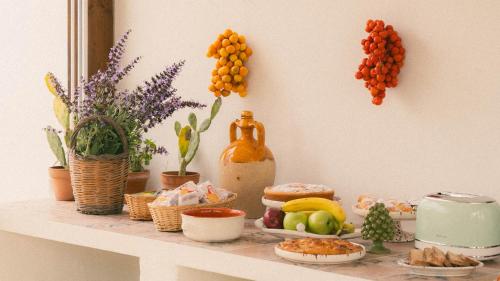 a shelf with food and fruits and plants on it at Tenuta Doxi in Gallipoli