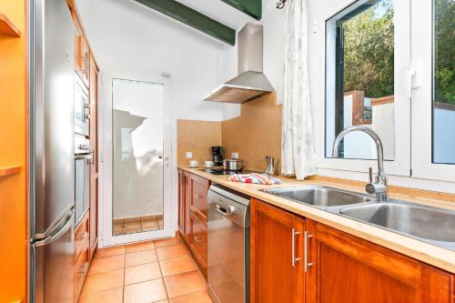 a kitchen with a sink and a window at Villa Casa Bonita by Villa Plus in Alaior