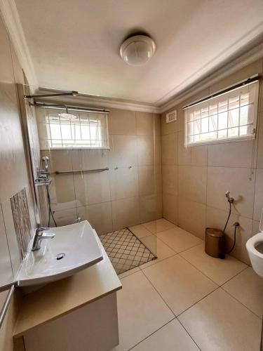 a bathroom with a sink and a toilet in it at Nsimbini 430 Lena Ahrens in Durban