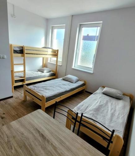 a room with two bunk beds and a table at Golenicka Przystań Golenice 73a in Golenice