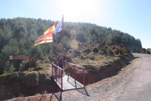 a flag on a gate on the side of a road at Casa Francho in Laspaúles