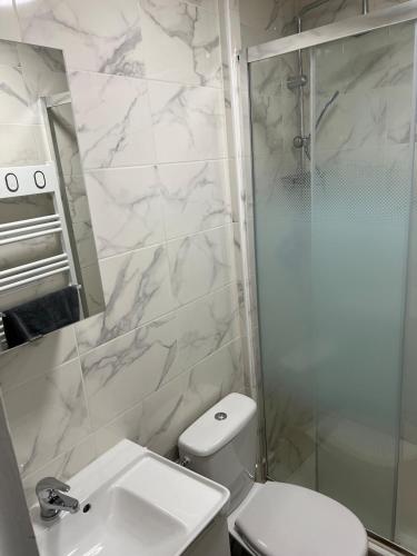 a bathroom with a shower and a toilet and a sink at Studio - Le Bourgogne 21 in Orléans