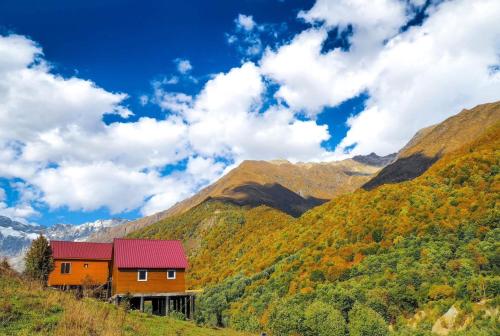 a house on a hill with mountains in the background at SkyGona in Ghebi