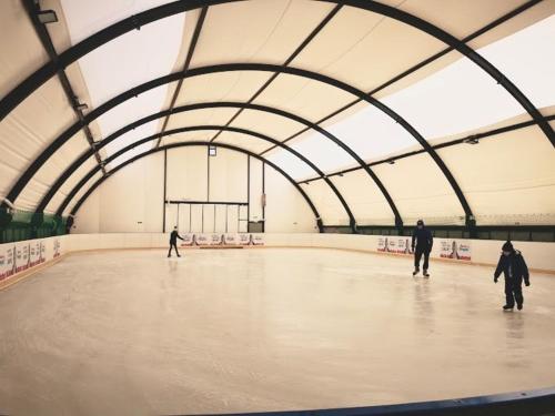 a group of people skating in a skating rink at MOSiR Reda in Reda