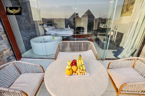 a table with a plate of fruit on it at Giza Inn Comfort view in Cairo