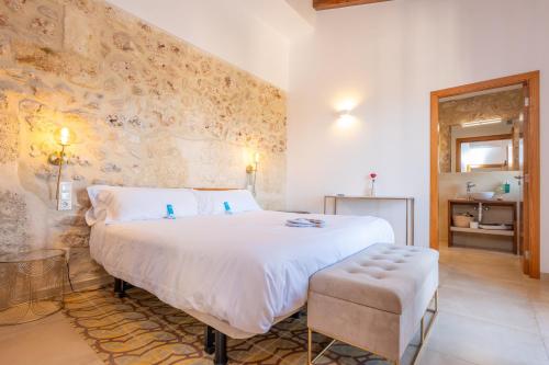 a bedroom with a large white bed in a room at Cas Català in Sineu