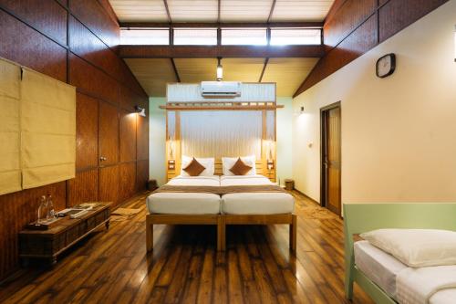 a bedroom with two beds in a room at Discovery Village Kabini in Antarasante