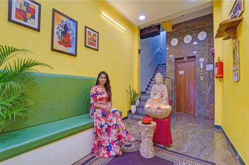 a woman standing in the hallway of a house at FabHotel Martine's Residency - French Colony, 5 Mins from Rock Beach in Puducherry
