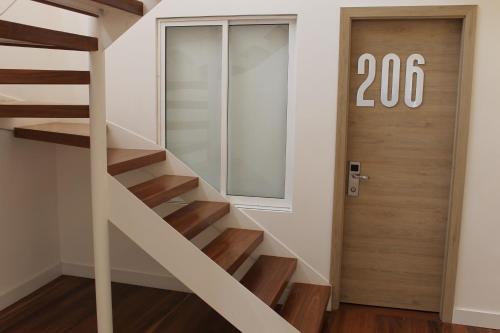 a staircase leading up to a door with a sign at Casa Hotel Boyaca Real in Bogotá