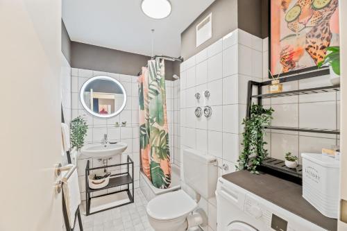 a bathroom with a toilet and a sink at Goldstadt Fancy Apartment in Pforzheim