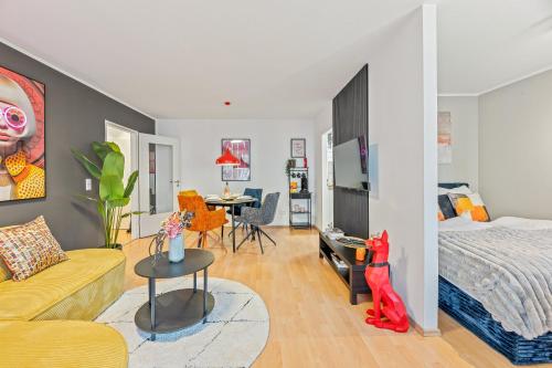 a bedroom with a bed and a living room at Goldstadt Fancy Apartment in Pforzheim