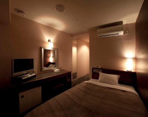 Postel nebo postele na pokoji v ubytování Center Hotel Toyota