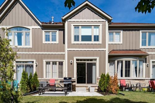 una casa con un tavolo da picnic di fronte di Blue Mountain Townhome - Patio Shuttle Trails a Collingwood