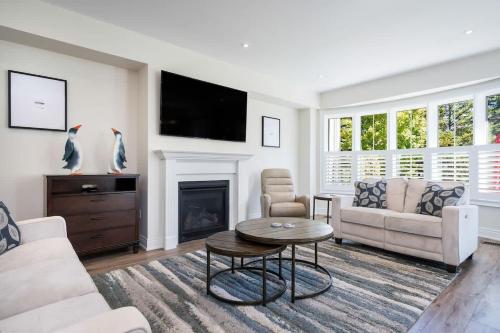 ein Wohnzimmer mit Sofa und Kamin in der Unterkunft Luxury Mountain Townhome - Shuttle Patio & Trails in Collingwood