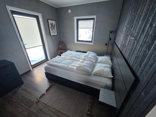 a bedroom with a bed and a large window at Winter cabin with Jacuzzi in Vestby
