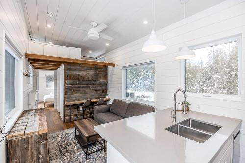 a kitchen and living room with a couch and a sink at The Hideaway - Tiny House in Eugenia