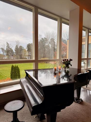 a large room with a table and a large window at Hotel Jollasranta Helsinki in Helsinki