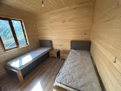 an empty cabin with a bed and a window at SkyGona in Ghebi