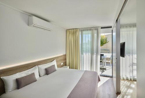 Ένα ή περισσότερα κρεβάτια σε δωμάτιο στο Aparthotel Comtat Sant Jordi