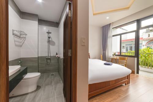 a bedroom with a bed and a shower and a toilet at Sóng homestay 4 - The spacious house - In the Prime location in Da Nang