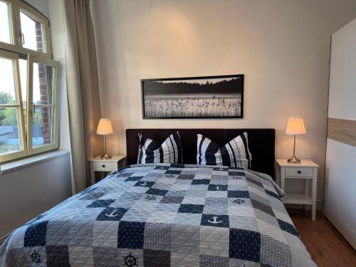 a bedroom with a bed with a quilt on it at Ferienwohnung Bress OG in Ueckermünde