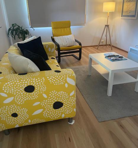 a living room with a couch and a table at Daisy House - Whittington - 10 minutes to central Geelong in Whittington