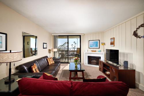 a living room with a couch and a fireplace at North Coast Village D204 in Oceanside