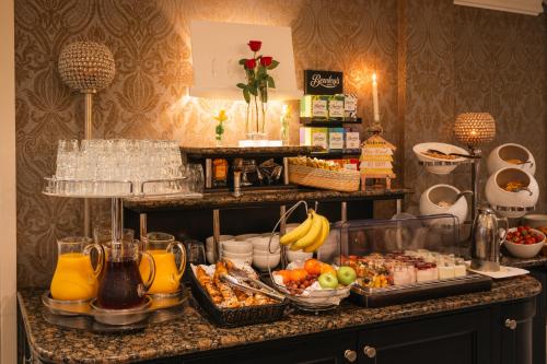a buffet with fruit and other food on a counter at The Fairview Boutique Hotel in Killarney