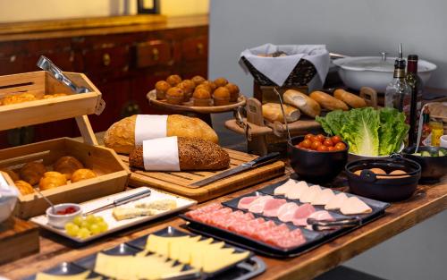 a table topped with lots of different types of food at Hotel Xanadu in London
