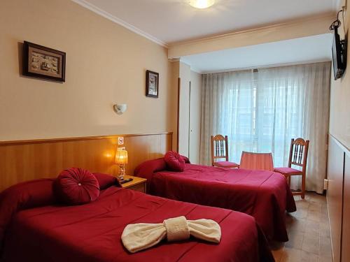 Postel nebo postele na pokoji v ubytování Hostal Ponte Dos Santos