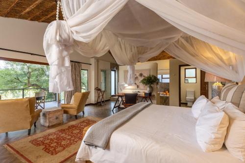a bedroom with a large bed with a canopy at Karongwe - Becks Safari Lodge in Hoedspruit